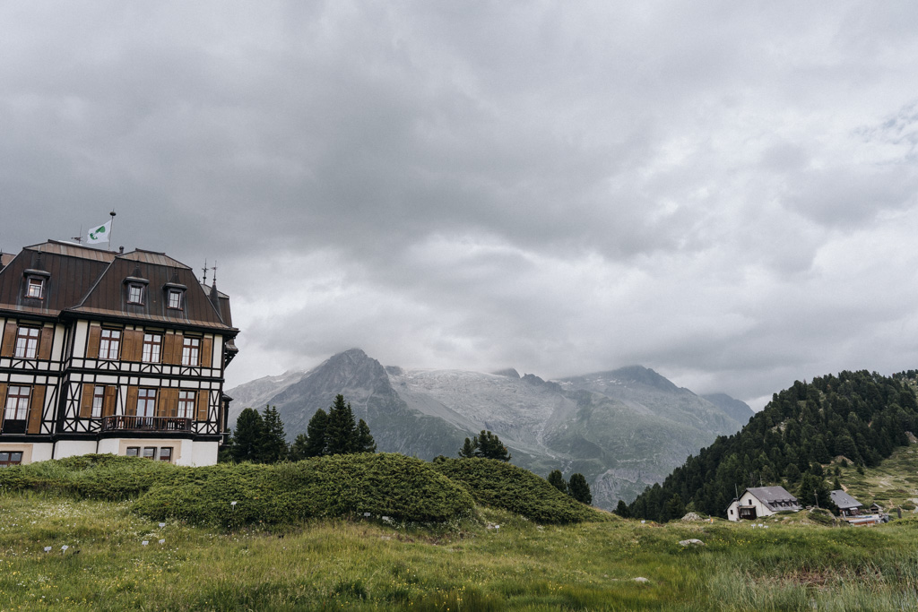Links ist die Villa Cassel umgeben von den 4000er Alpen, einem Wolkenmeer in der Schweiz und steht am Aletschgletscher